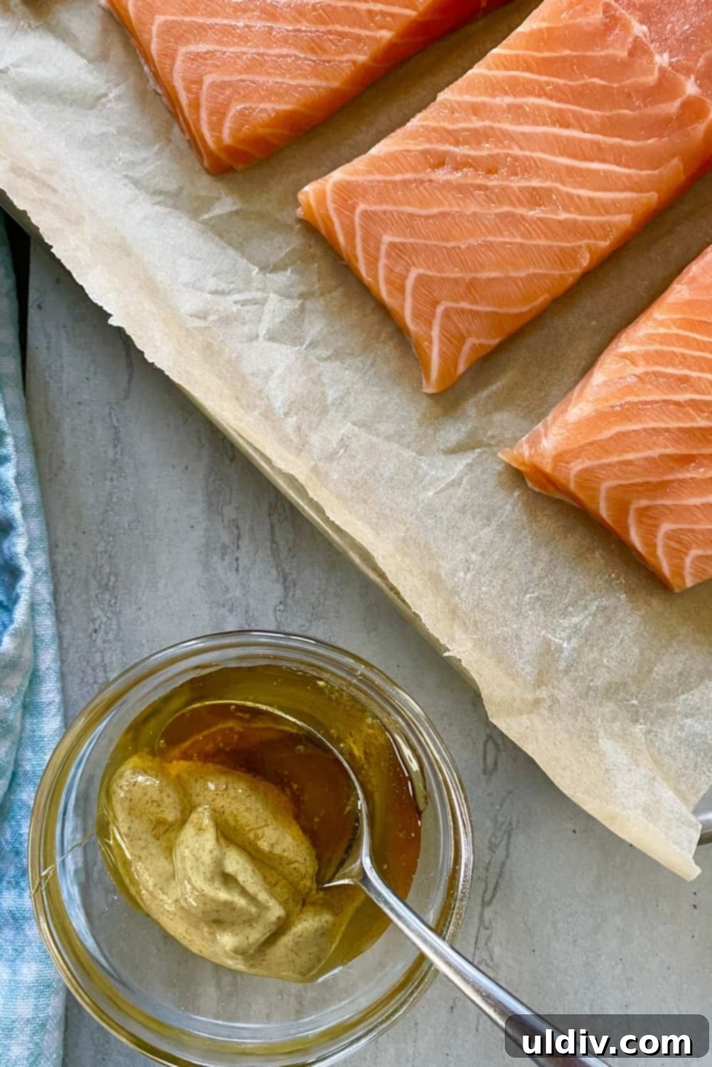 Golden Pecan Crusted Salmon with Honey Mustard 5 Mixing honey and Dijon mustard in a bowl and raw salmon.