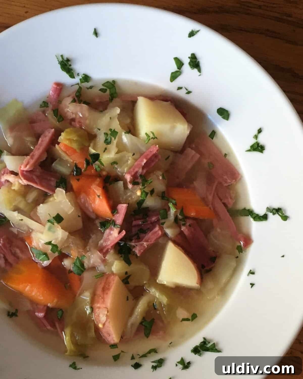 Hearty Slow Cooker Corned Beef Soup 2 hearty bowl of corned beef and cabbage soup, garnished with fresh parsley.