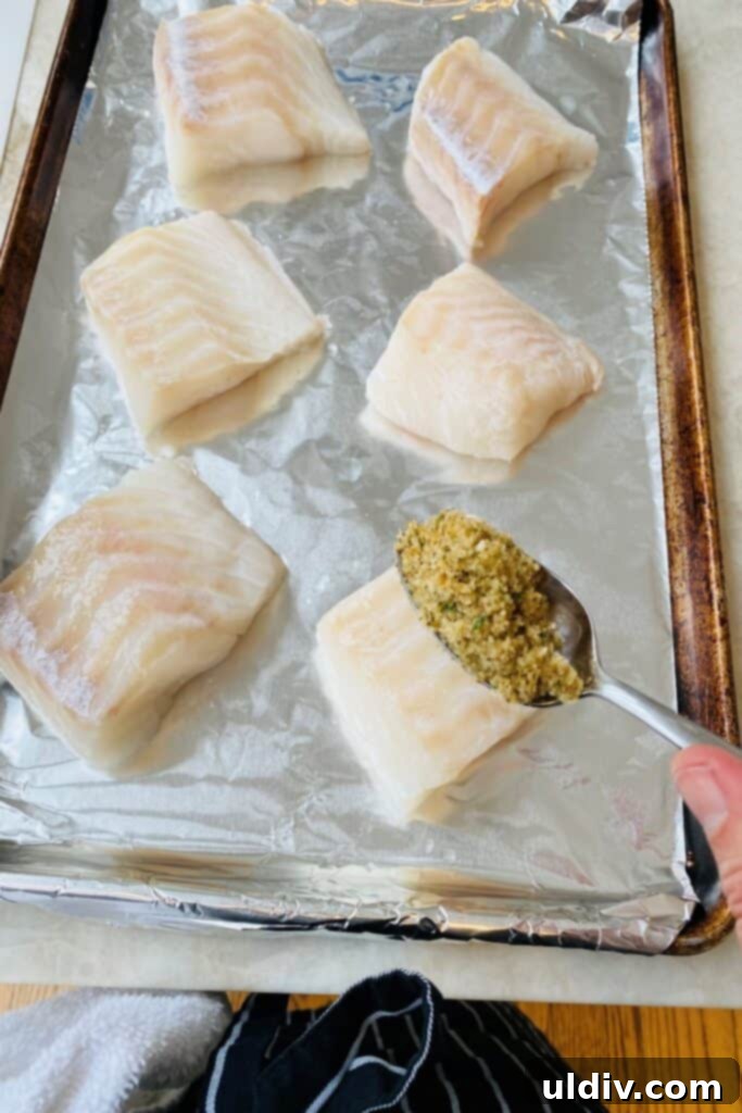 Golden Crusted Cod Oreganata 5 Adding a topping to cod.