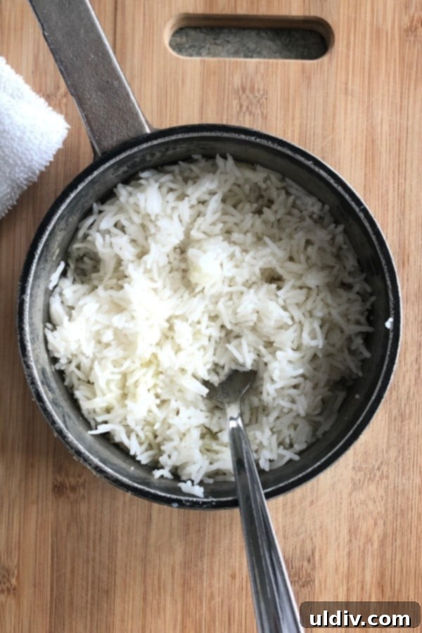 Homemade Fried Rice and Chicken Beats Takeout 3 A pot of perfectly cooked, fluffy white rice, ready to be transformed into delicious fried rice.
