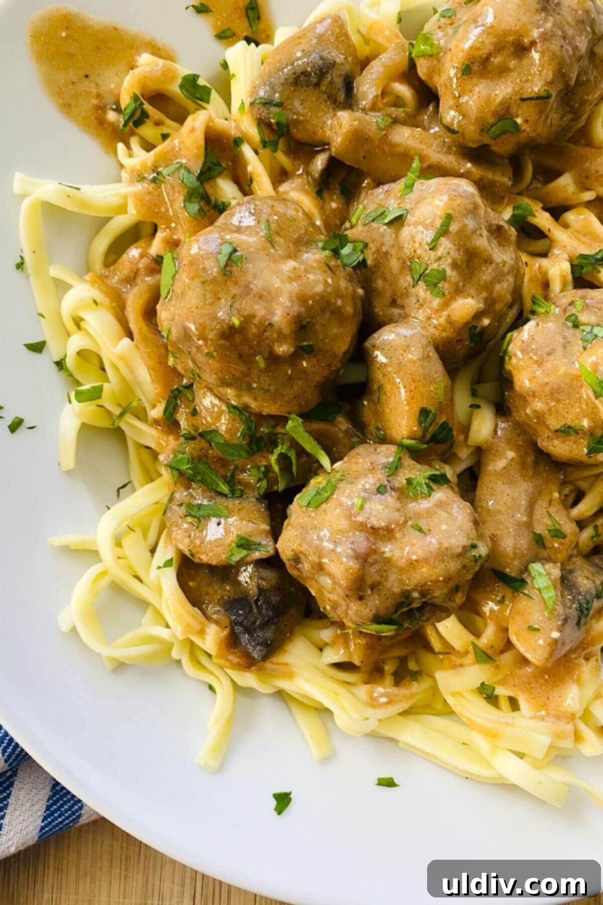Effortless Homemade Meatball Stroganoff 2 Stroganoff meatballs served over noodles.