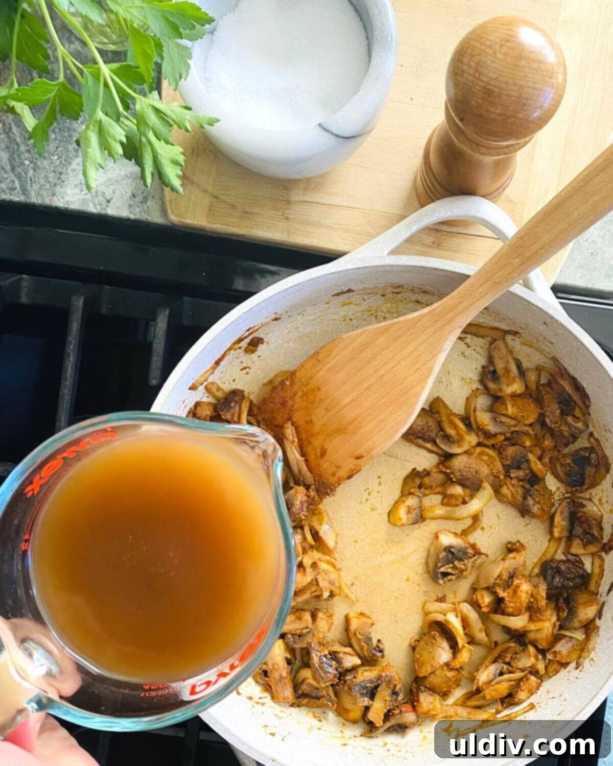 Effortless Homemade Meatball Stroganoff 11 Adding beef broth to stroganoff gravy.