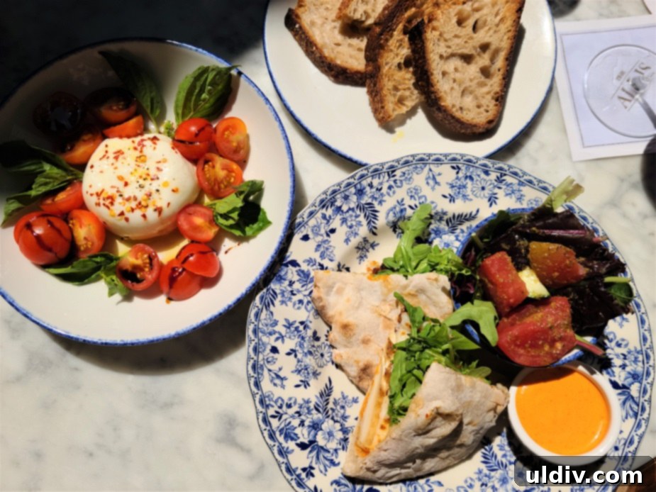 Close-up of burrata cheese with cherry tomatoes, basil, and chili flakes