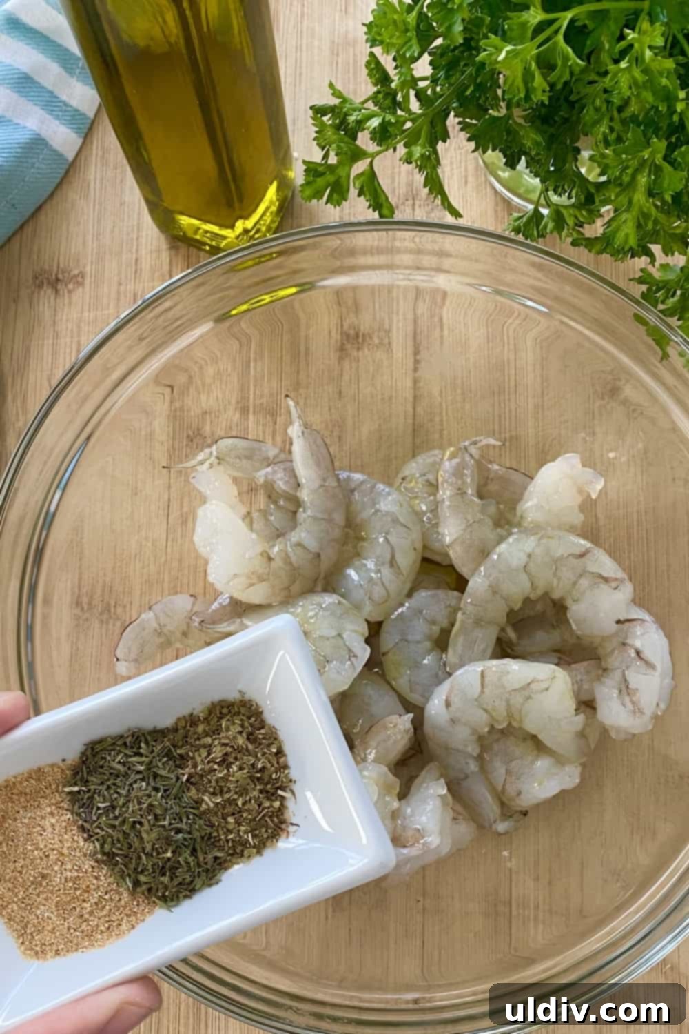Sun-Kissed Mediterranean Shrimp Tacos with Zesty Tzatziki 4 A bowl of raw shrimp awaits seasoning, alongside a small dish containing a medley of aromatic spices.
