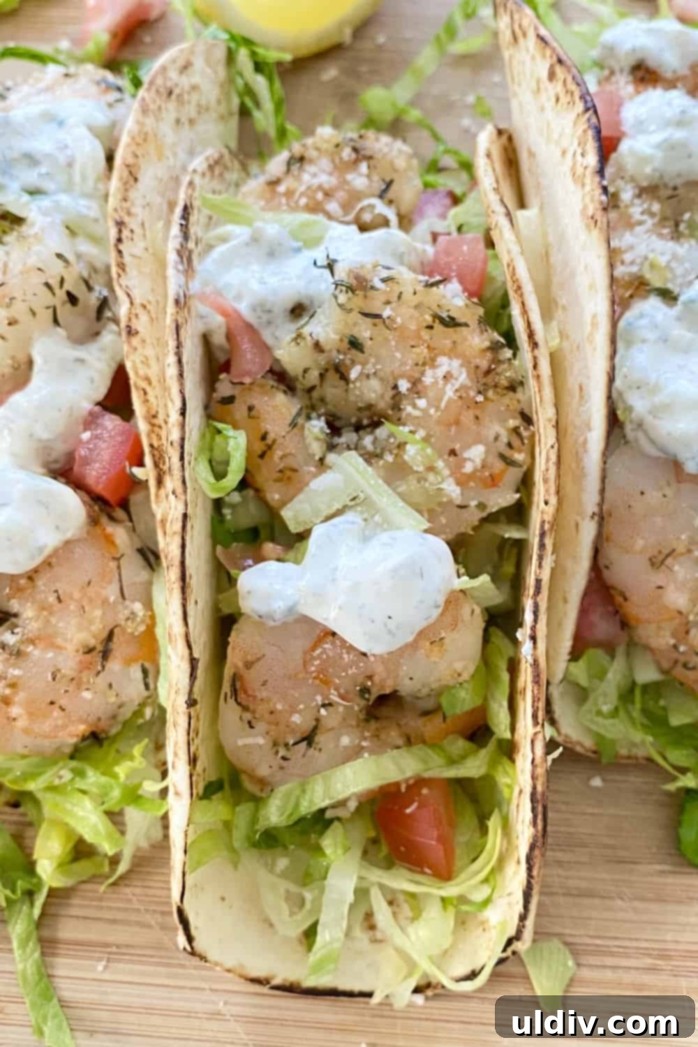 Sun-Kissed Mediterranean Shrimp Tacos with Zesty Tzatziki 9 A beautifully prepared single shrimp taco, brimming with Mediterranean flavors, served in a soft tortilla.