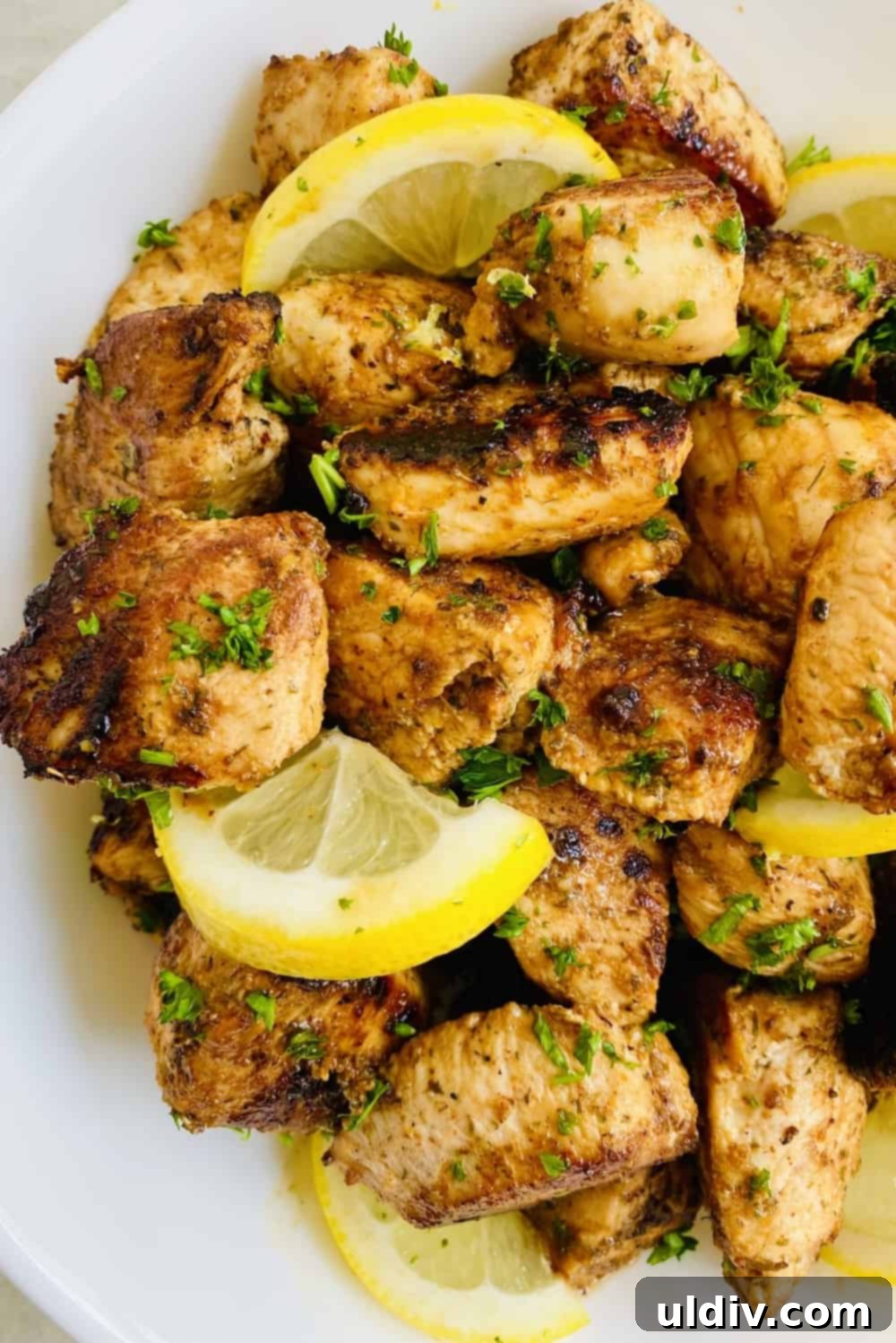 Perfectly Succulent Lemon Herb Chicken 2 Sautéed Lemon Herb Chicken with lemon slices and fresh parsley, ready to serve.