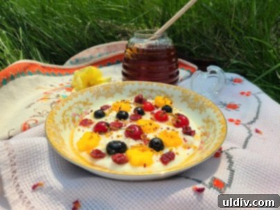 Summer's Sweetest Blueberry Creations 13 A bowl of creamy semolina pudding generously topped with fresh blueberries, bee pollen, honey, and dried rose petals.