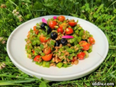 Summer's Sweetest Blueberry Creations 16 A vibrant farro salad featuring garden peas, peppers, cherry tomatoes, herbs, and fresh blueberries, drizzled with honey vinaigrette.