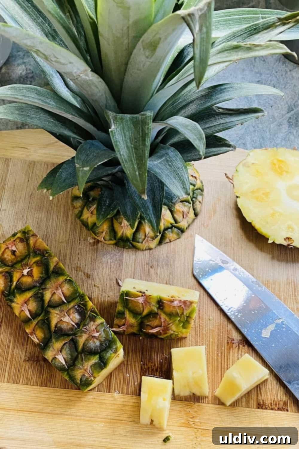 Tropical Pineapple Bread Pudding 4 A cut up fresh pineapple on a cutting board.