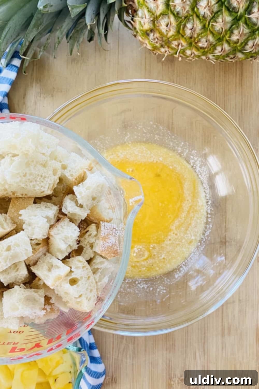 Tropical Pineapple Bread Pudding 6 Bread cubes and a bowl of melted butter.