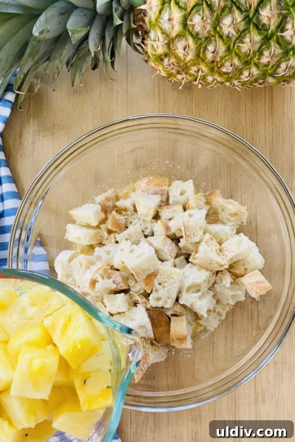 Tropical Pineapple Bread Pudding 7 Combining fresh pineapple cubes with seasoned bread cubes.