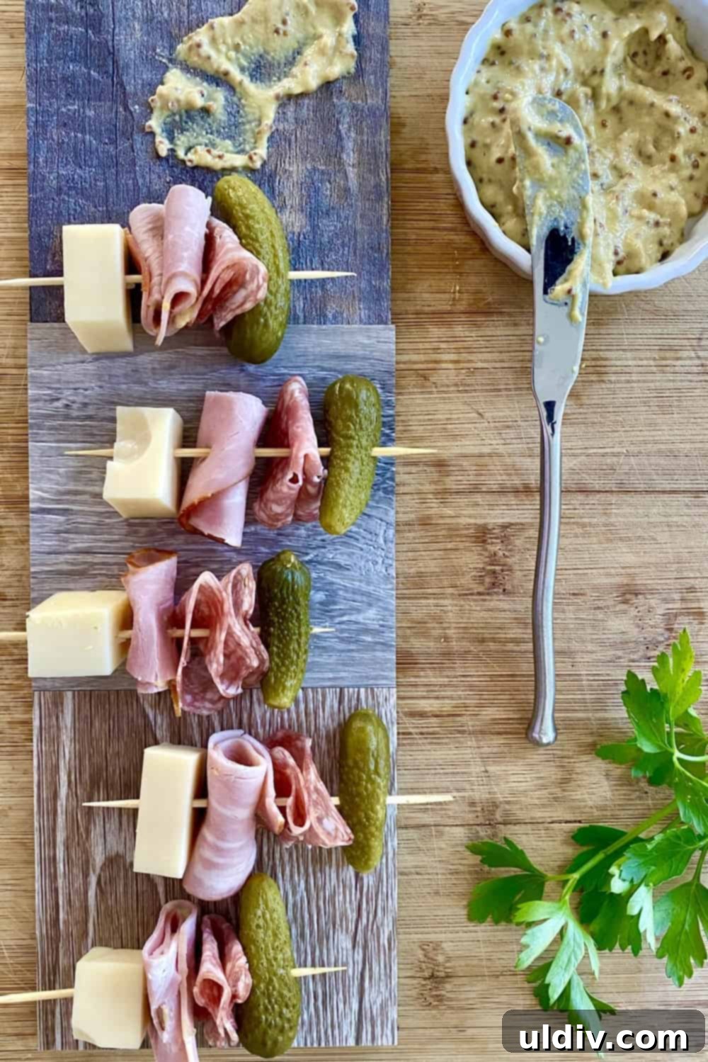 Mini Cuban Sandwich Skewers 2 Cuban sandwich appetizer skewers with ham, Swiss cheese, salami and dill pickle.