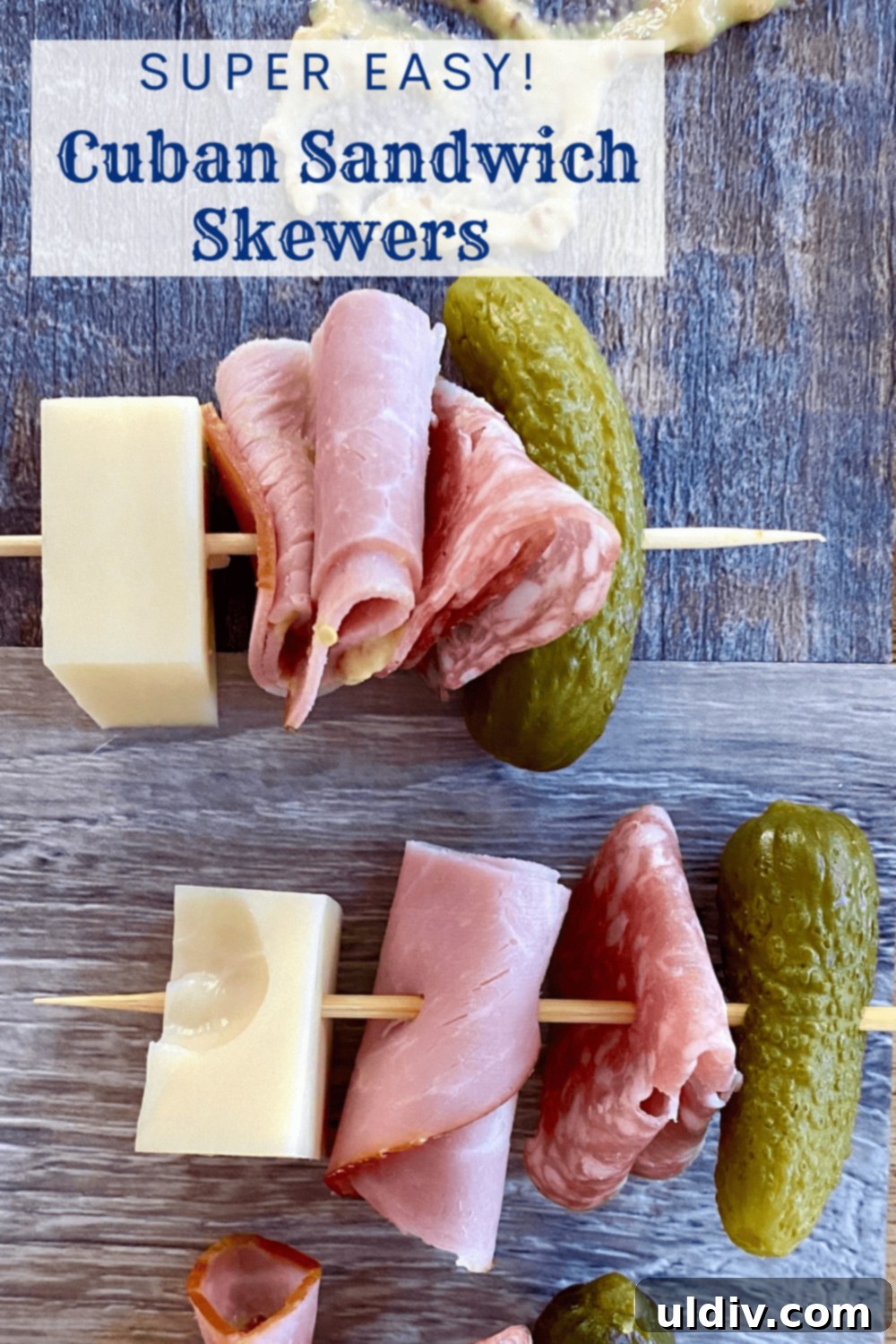 Cuban Skewer Bites 7 2 skewers with ham, Swiss cheese, salami, and a mini dill pickle.