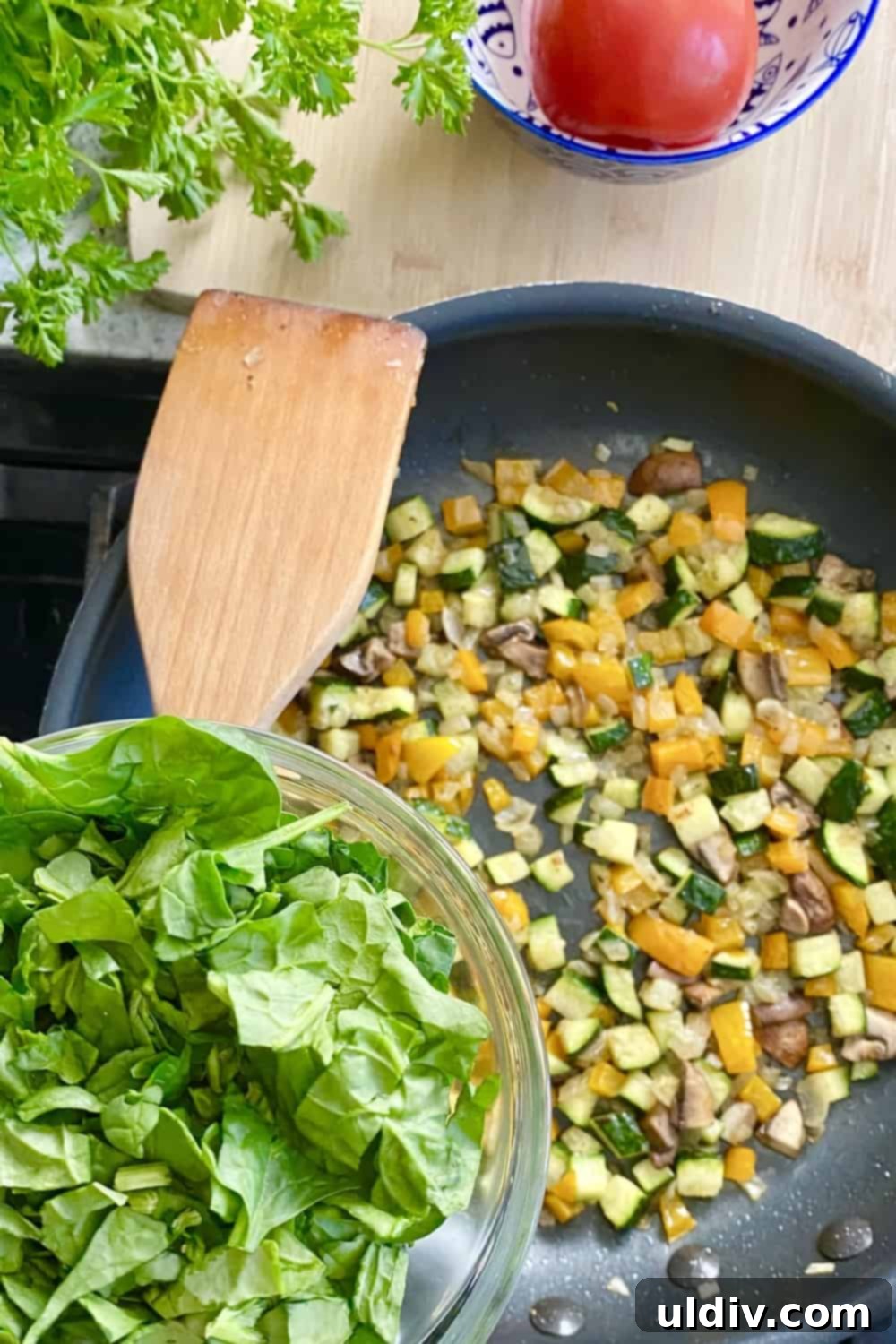 Effortless Baked Frittata 6 Colorful vegetables, including mushrooms, zucchini, and bell peppers, sautéing in a pan for a frittata.