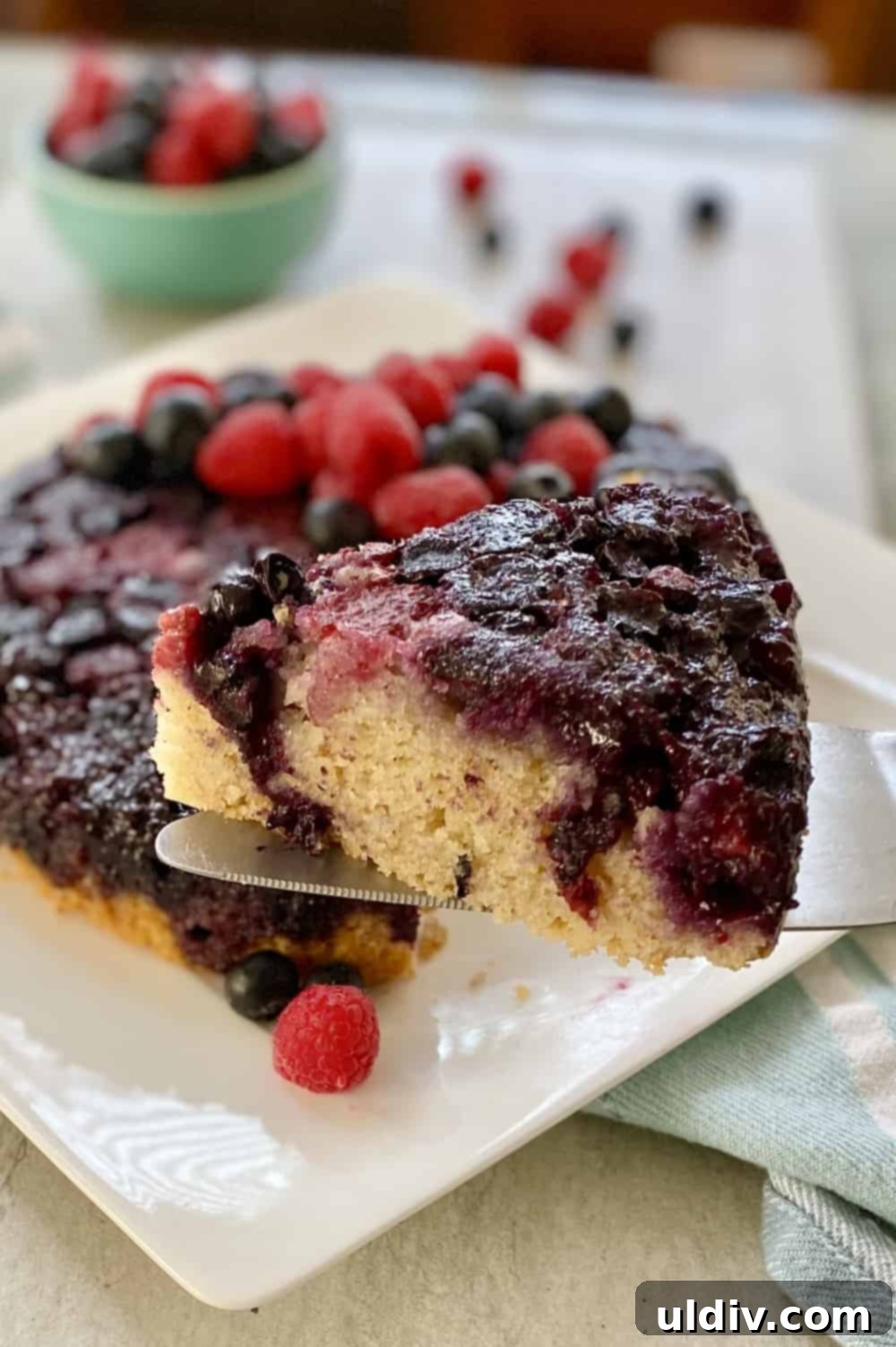 Berry Burst Upside Down Cake 3 A beautiful wedge of berry upside down cake, highlighting its moist texture and fruit topping.