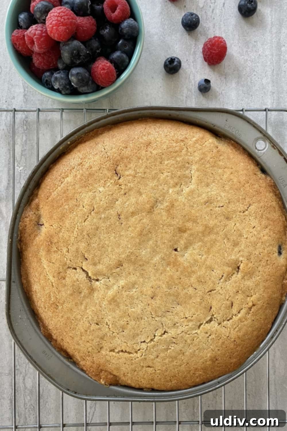 Berry Burst Upside Down Cake 7 A freshly baked Double Berry Upside Down Cake cooling in its pan.