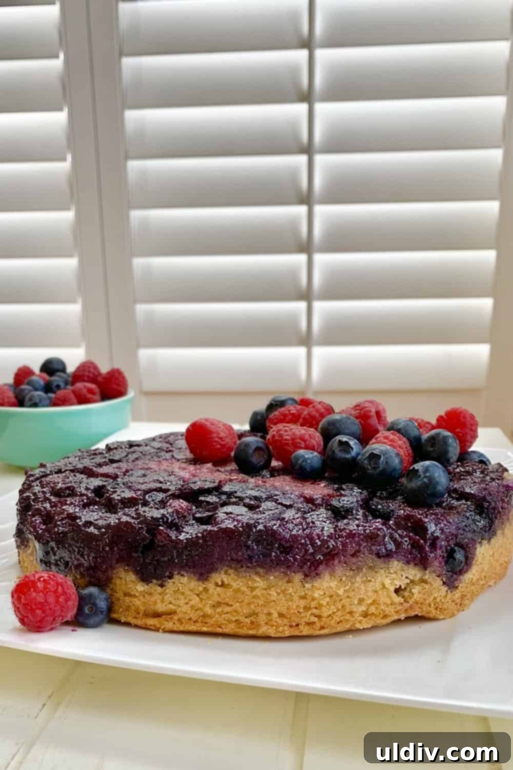 Berry Burst Upside Down Cake 9 A stunning whole Double Berry Upside Down Cake with a beautiful, glistening berry topping.