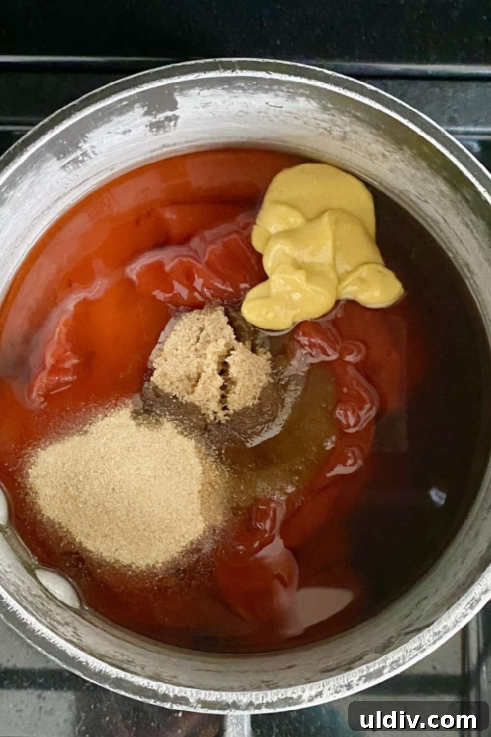 Easy Homemade BBQ Sauce 6 A vibrant mix of ketchup, mustard, brown sugar, and hot sauce, ready to be combined for a flavorful BBQ sauce.