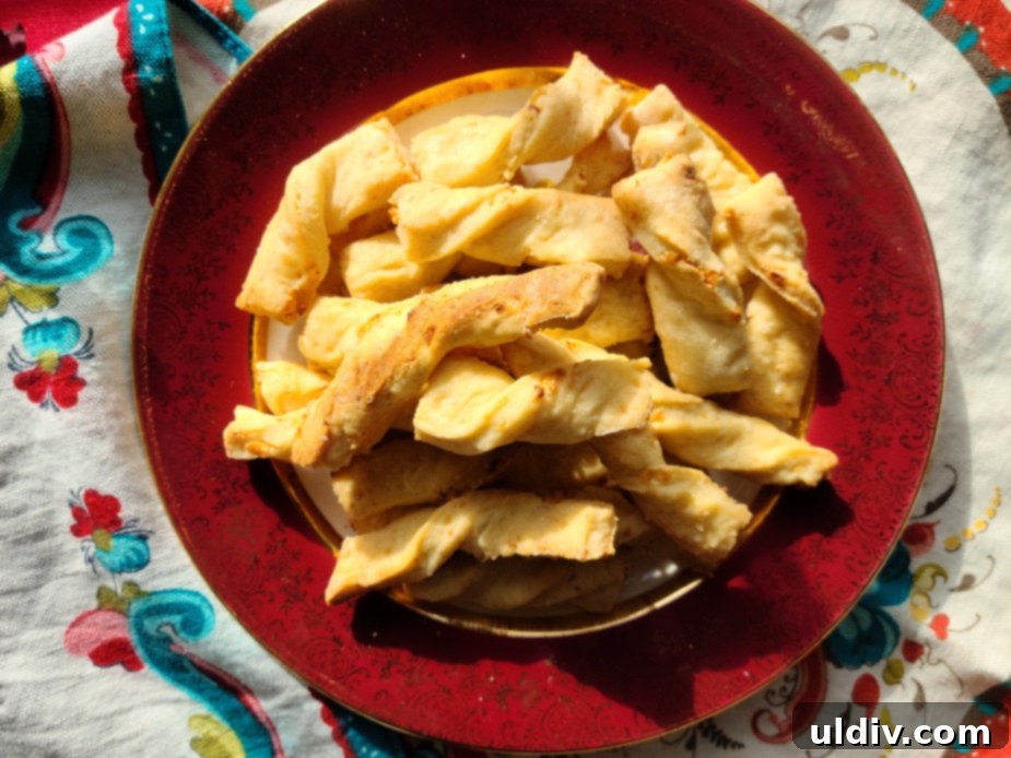 Golden Cheese Straws for Effortless Entertaining 6 Close up of a single Feta Cheese Straw, golden and crispy.