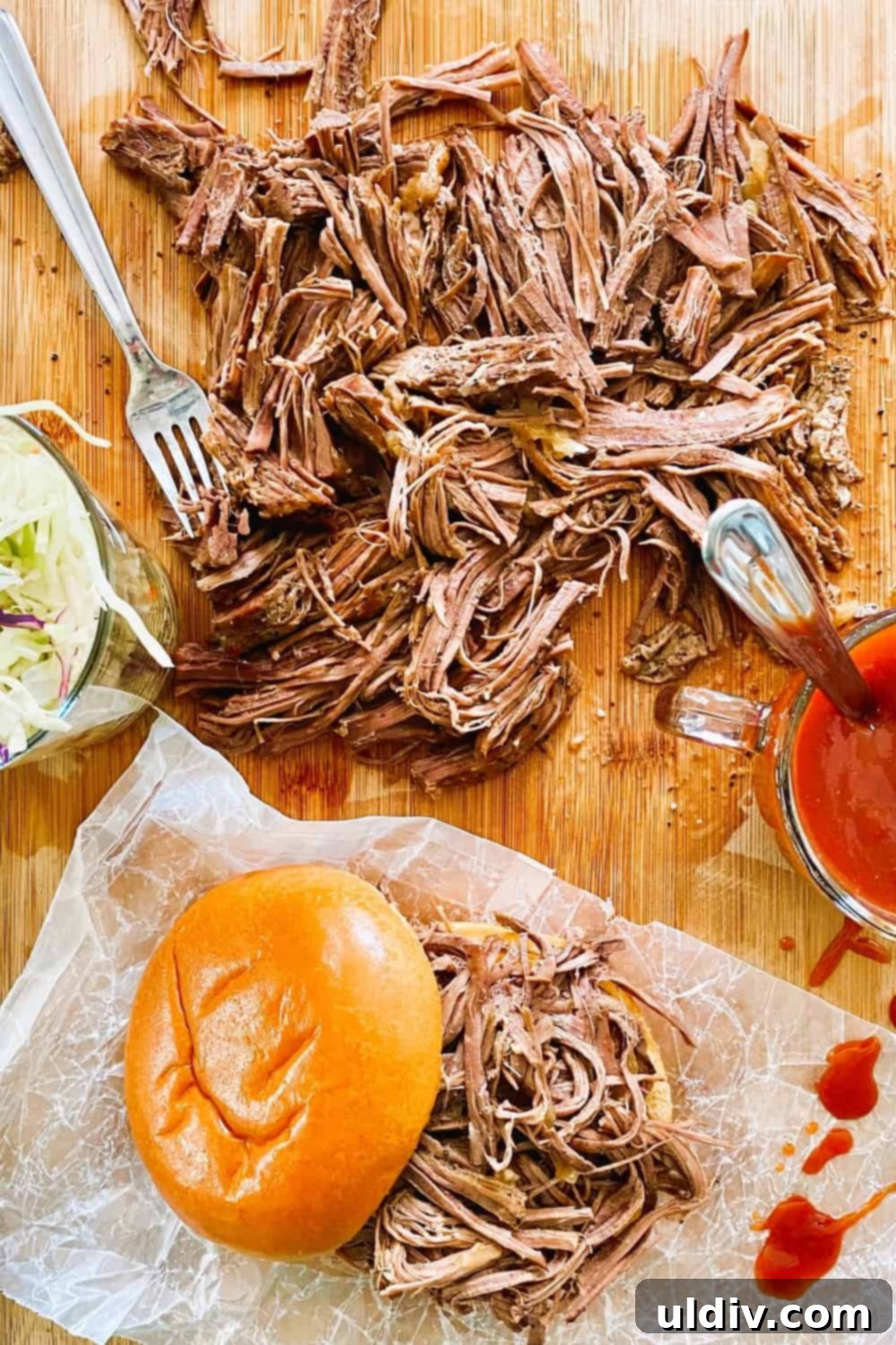 Tender Instant Pot BBQ Brisket Sandwiches 3 Close-up of perfectly shredded beef brisket on a soft brioche bun, ready for toppings.