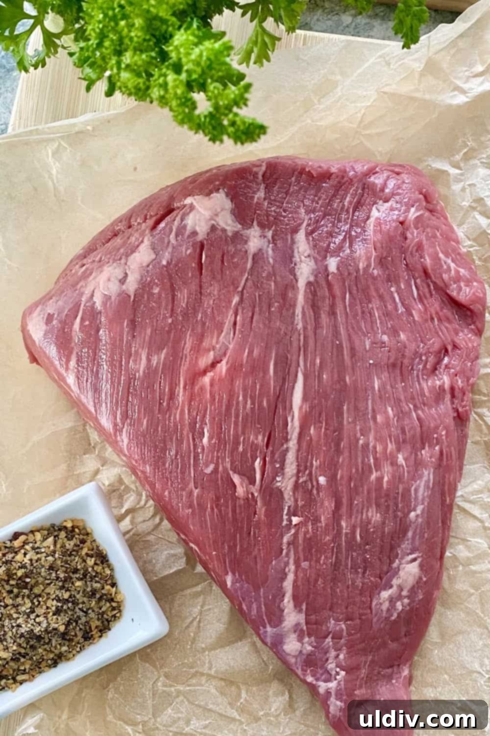 Tender Instant Pot BBQ Brisket Sandwiches 4 Flat beef brisket generously seasoned with Montreal steak seasoning on a cutting board.