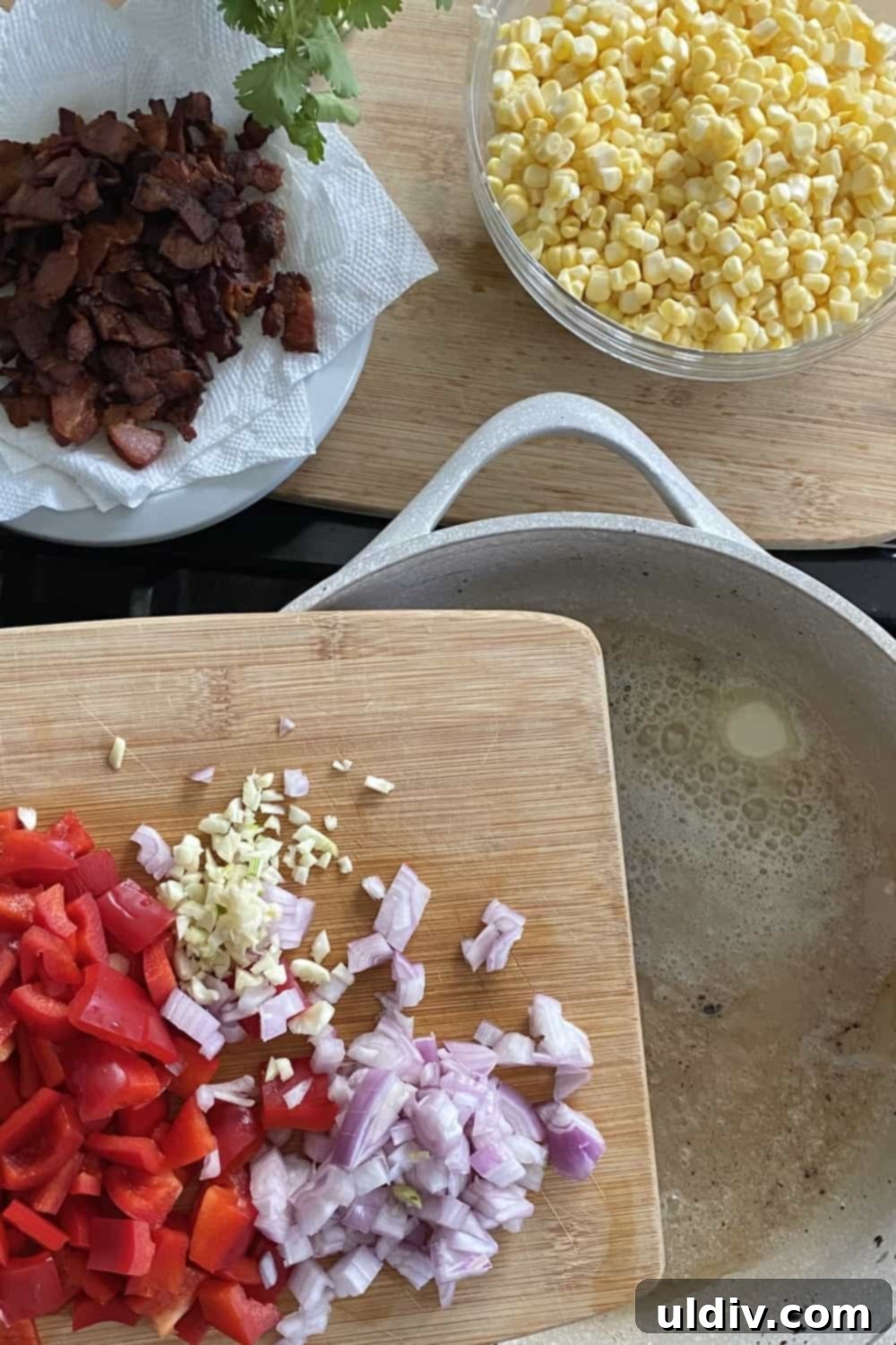 Smoky Bacon Sweet Corn Salad 6 Diced red bell pepper, sliced shallots, and minced garlic ready to be sautéed in a pan