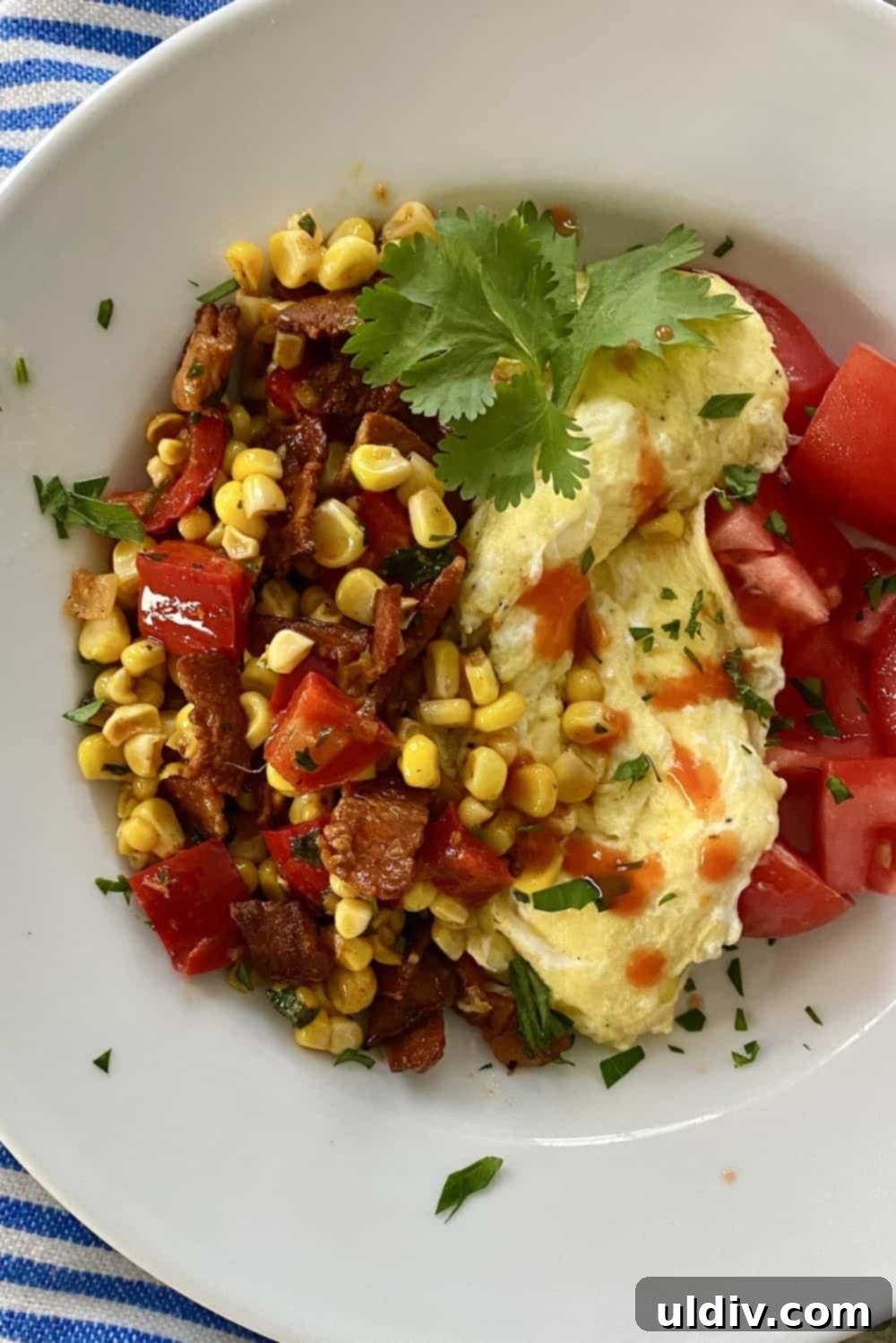 Creamy scrambled eggs served alongside a generous portion of colorful sweet corn salad with bacon, a perfect brunch or breakfast pairing.