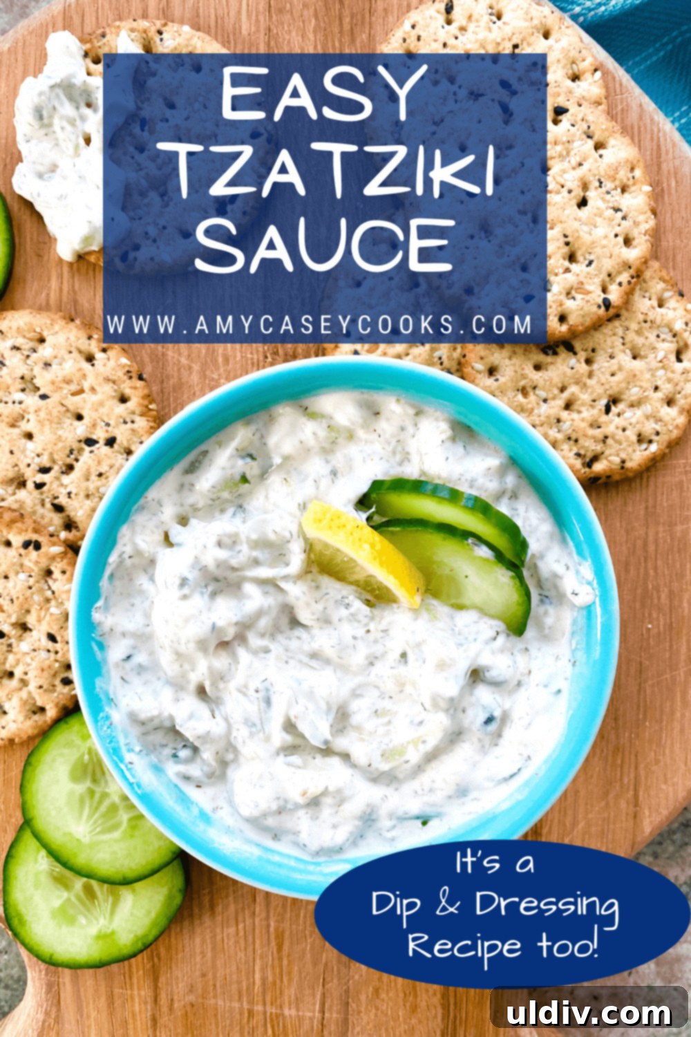Effortless Tzatziki Dip and Dressing 10 A beautifully presented dish of homemade tzatziki sauce, garnished with fresh dill, served with a variety of dippers including crisp cucumber slices and golden crackers, ready to be enjoyed.