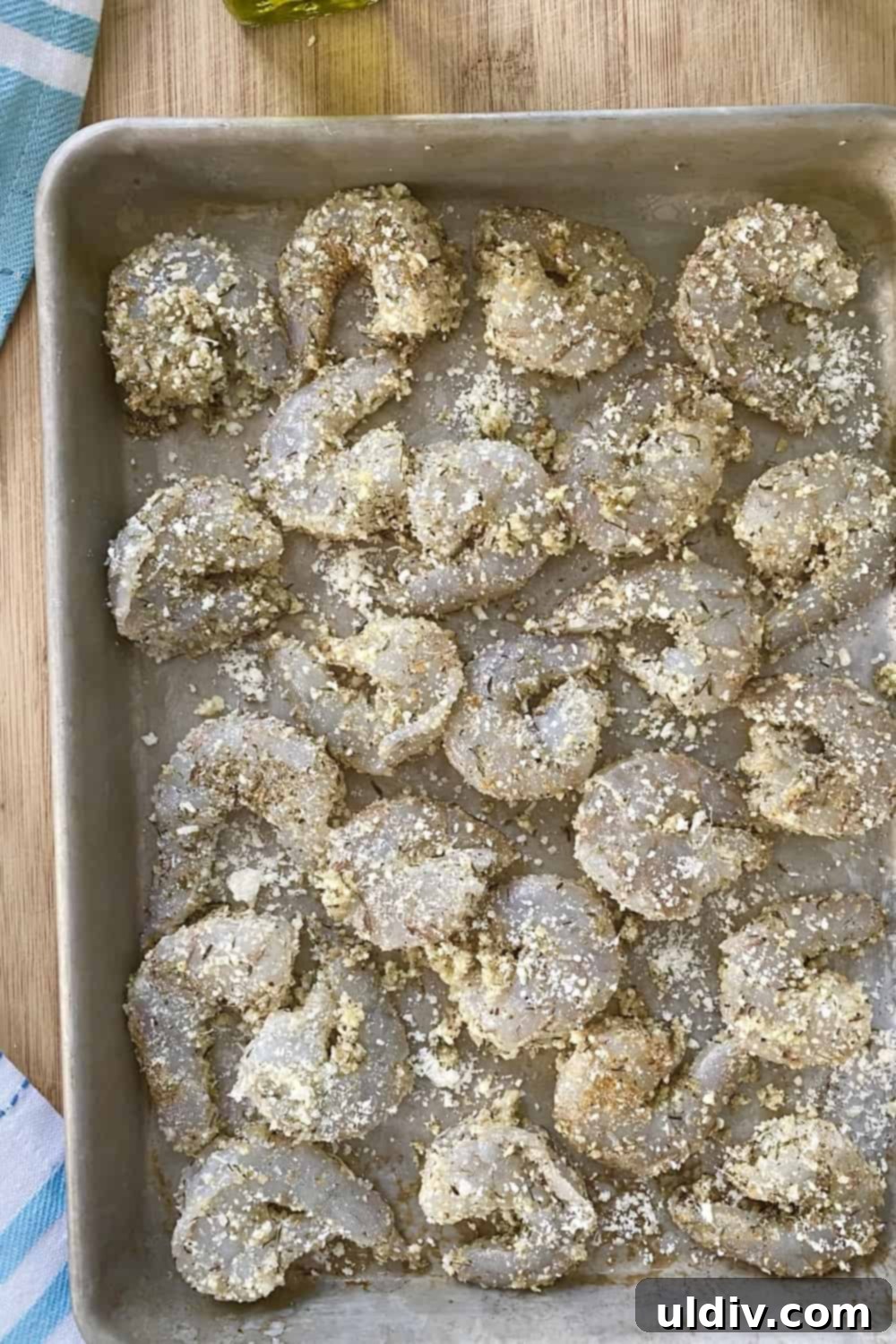 Crispy Parmesan Roasted Shrimp 7 Seasoned shrimp on a baking sheet.