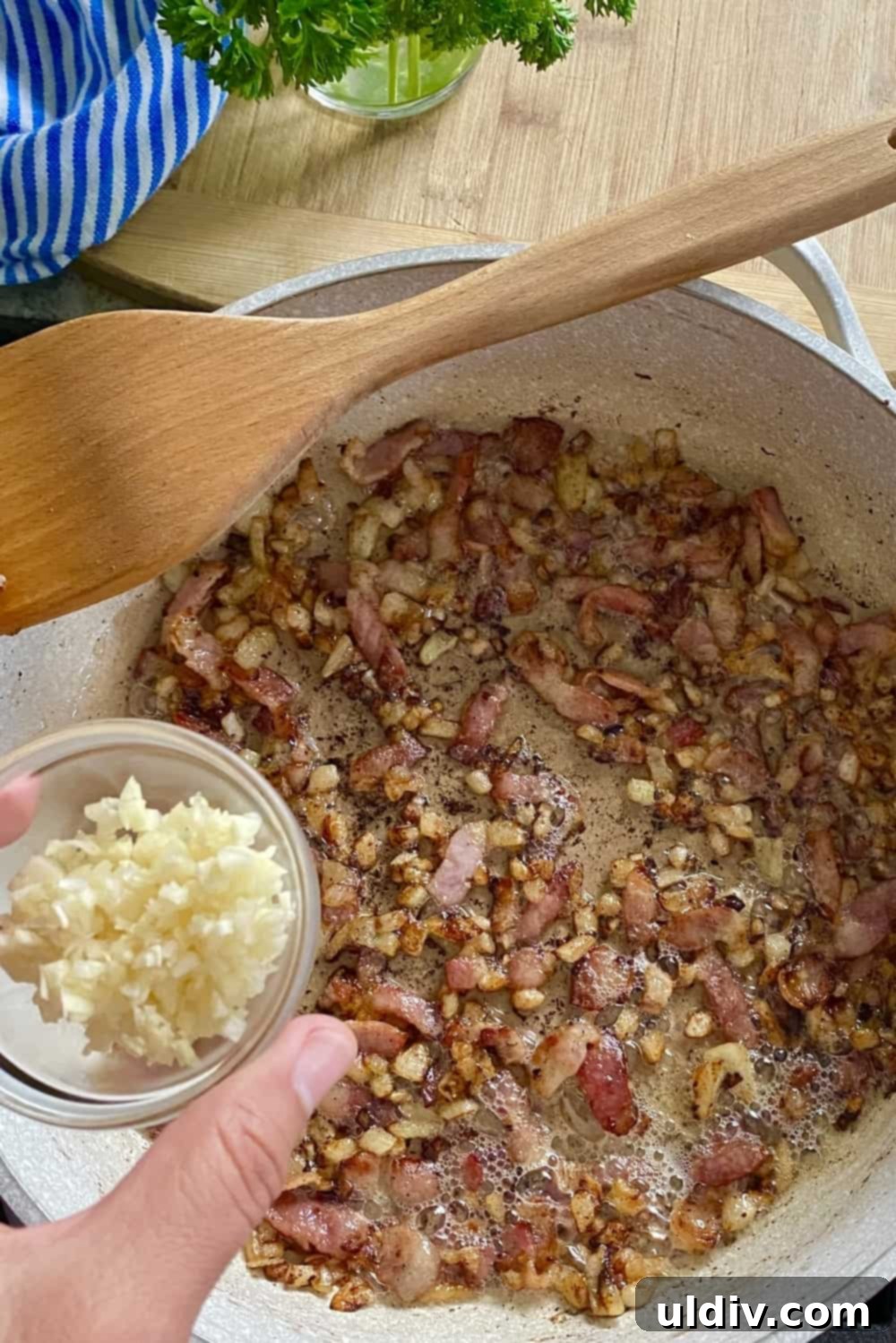Quinoa Egg Muffins: Breakfast Made Easy 4 A large sauté pan with beautifully sautéed onion, crispy bacon, and fragrant minced garlic, ready to be added to the muffin mixture.