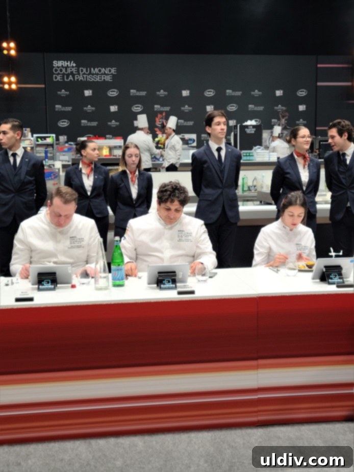 Chef Mauro Colagreco intently judging a dessert, a renowned three-Michelin star chef at the World Pastry Cup.