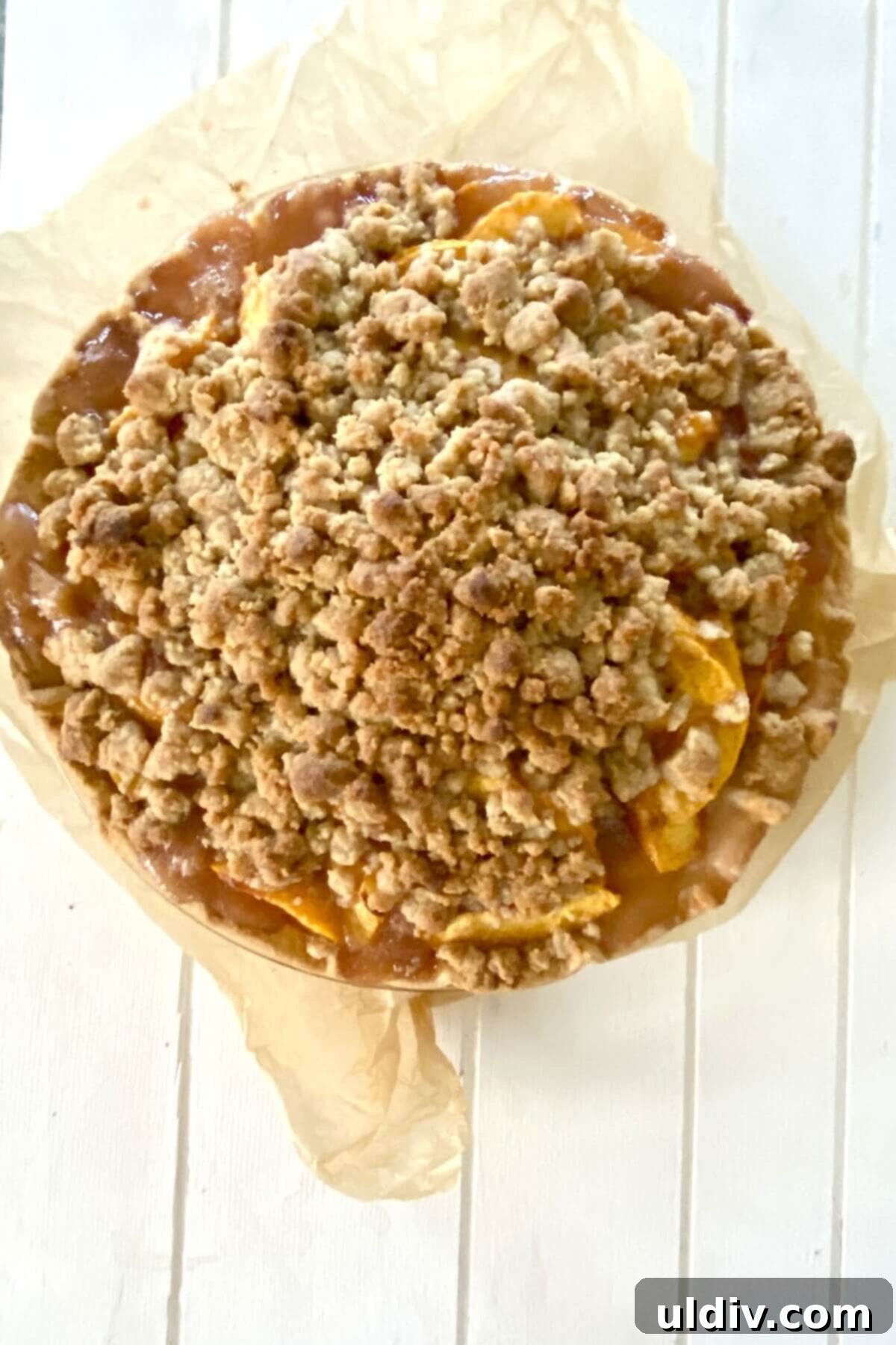 Crisp Bottom Peach Crumble Pie 11 A beautifully baked peach crumble pie, golden brown and bubbly.