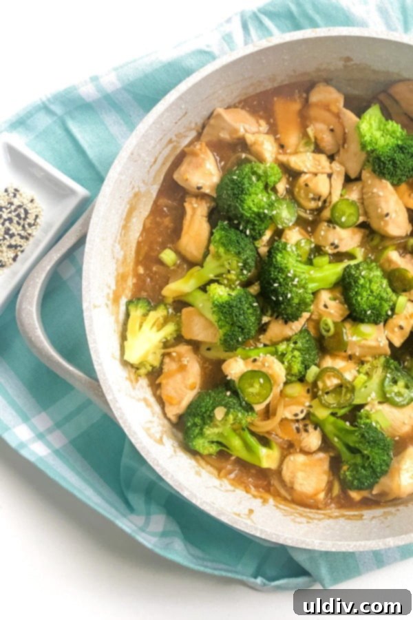 Fiery Jalapeno Chicken Broccoli Stir Fry 4 A close-up shot of spicy chicken, broccoli, and jalapeno peppers stir-frying in a hot pan.