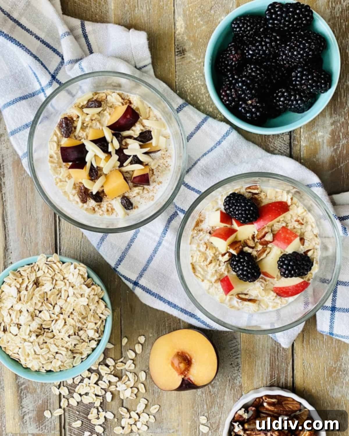 Effortless Overnight Oats 3 Overnight oats prepared with fresh plums, apple slices, plump raisins, and a sprinkle of various nuts, showcasing a vibrant and wholesome meal.
