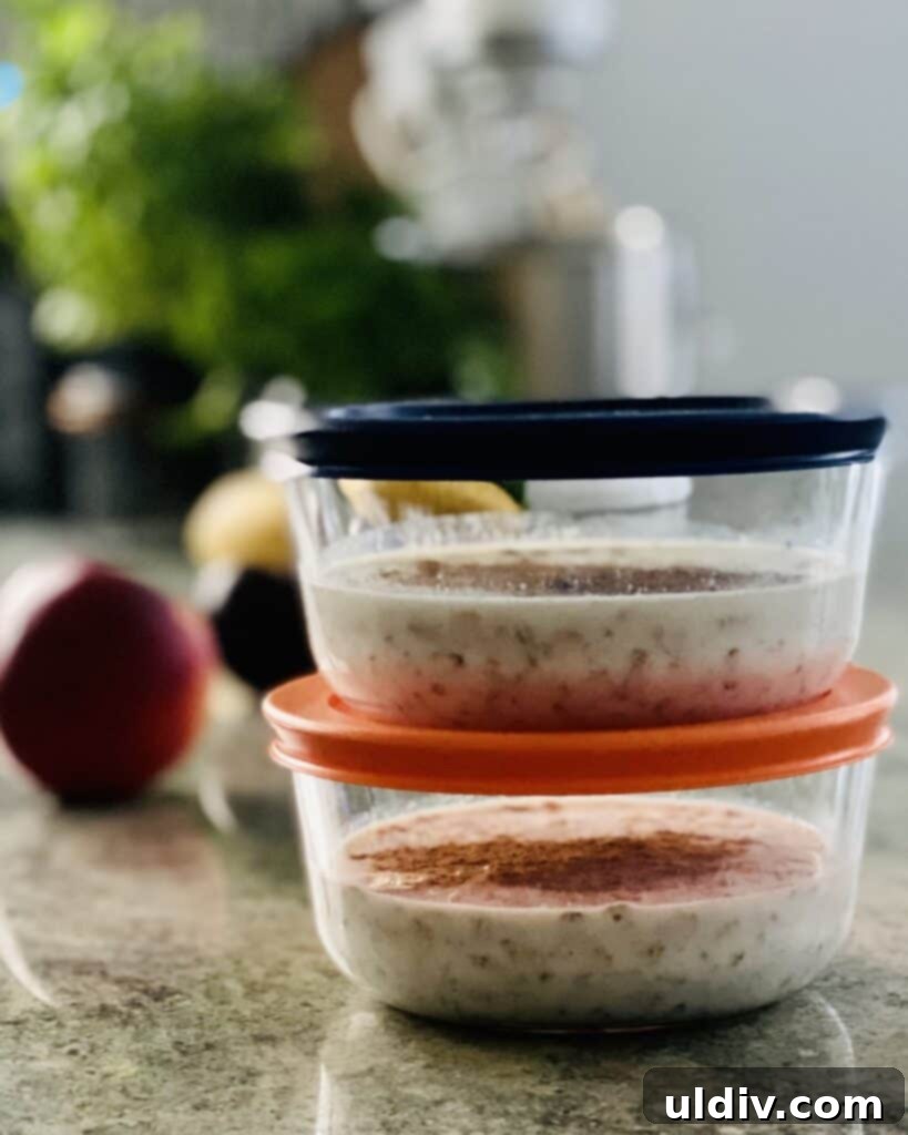 Effortless Overnight Oats 5 Four individual glass jars filled with overnight oats, topped with various fruits and nuts, ready for refrigeration.