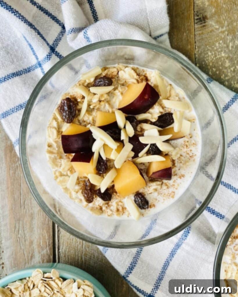 Effortless Overnight Oats 7 Overnight oats in a jar, beautifully topped with sliced plums, golden raisins, and crunchy almonds.