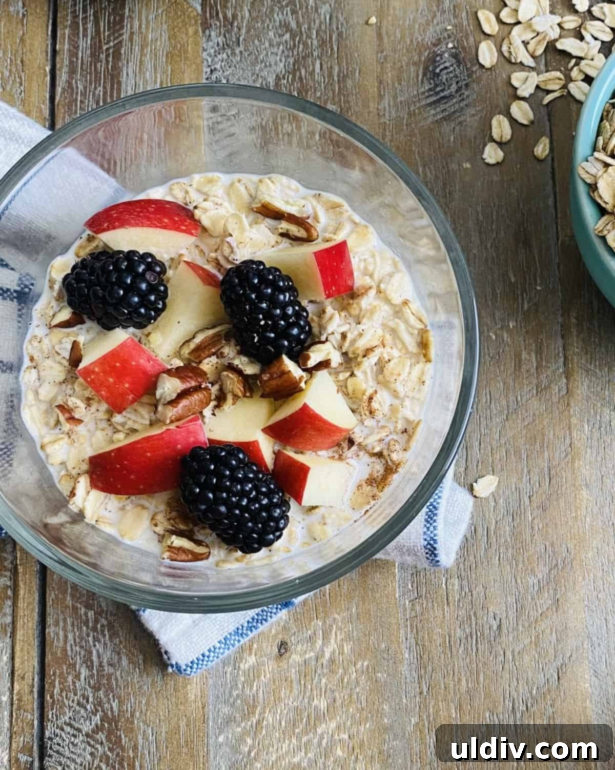 Effortless Overnight Oats 8 A vibrant bowl of overnight oats garnished with fresh apples and mixed berries, showcasing a healthy and colorful breakfast.