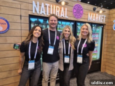 Smiling individual reconnecting with Pitaya Foods representatives at the National Restaurant Association Show 2023