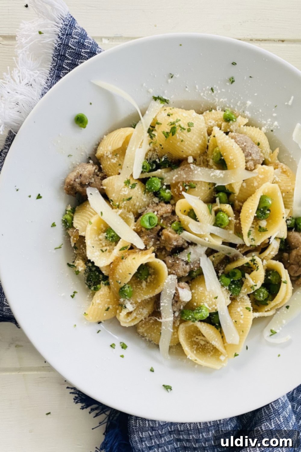 30-Minute Sausage and Pea Pasta 8 A bowl of pasta and peas with shaved Parmesan.