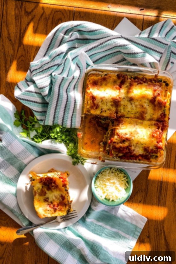 Hearty Spinach and Sausage Lasagna 7 baked lasagna with one piece removed, showcasing the layers