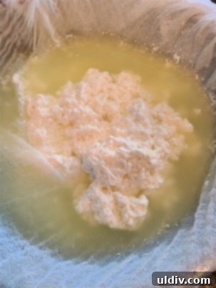 The Sour Milk Secret Homemade Cheese and Happy Memories 4 Pouring curdled milk into a cheesecloth-lined colander