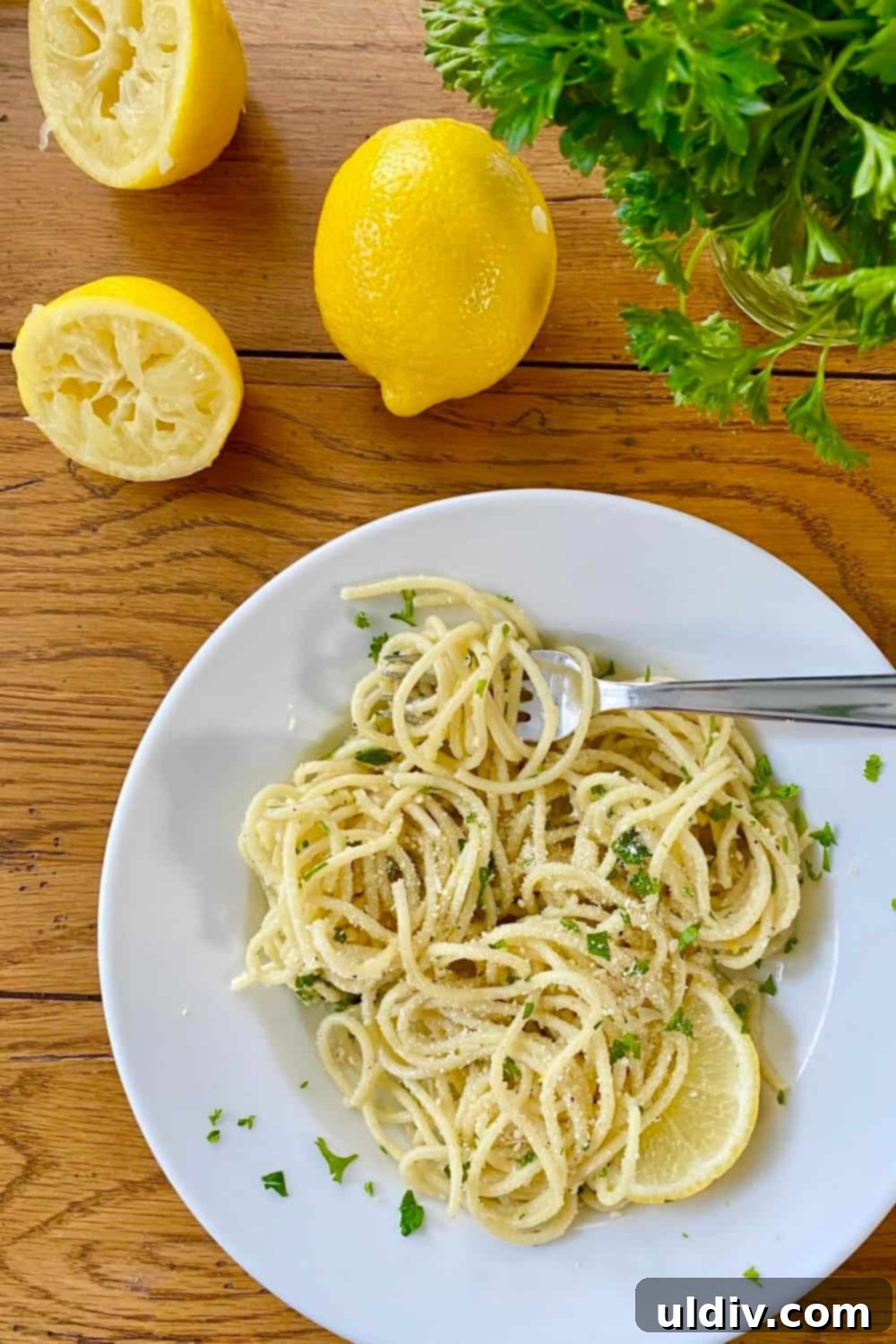 Creamy Garlic Parmesan Noodles 2 bowl of buttered noodles with Parmesan, lemons and parsley