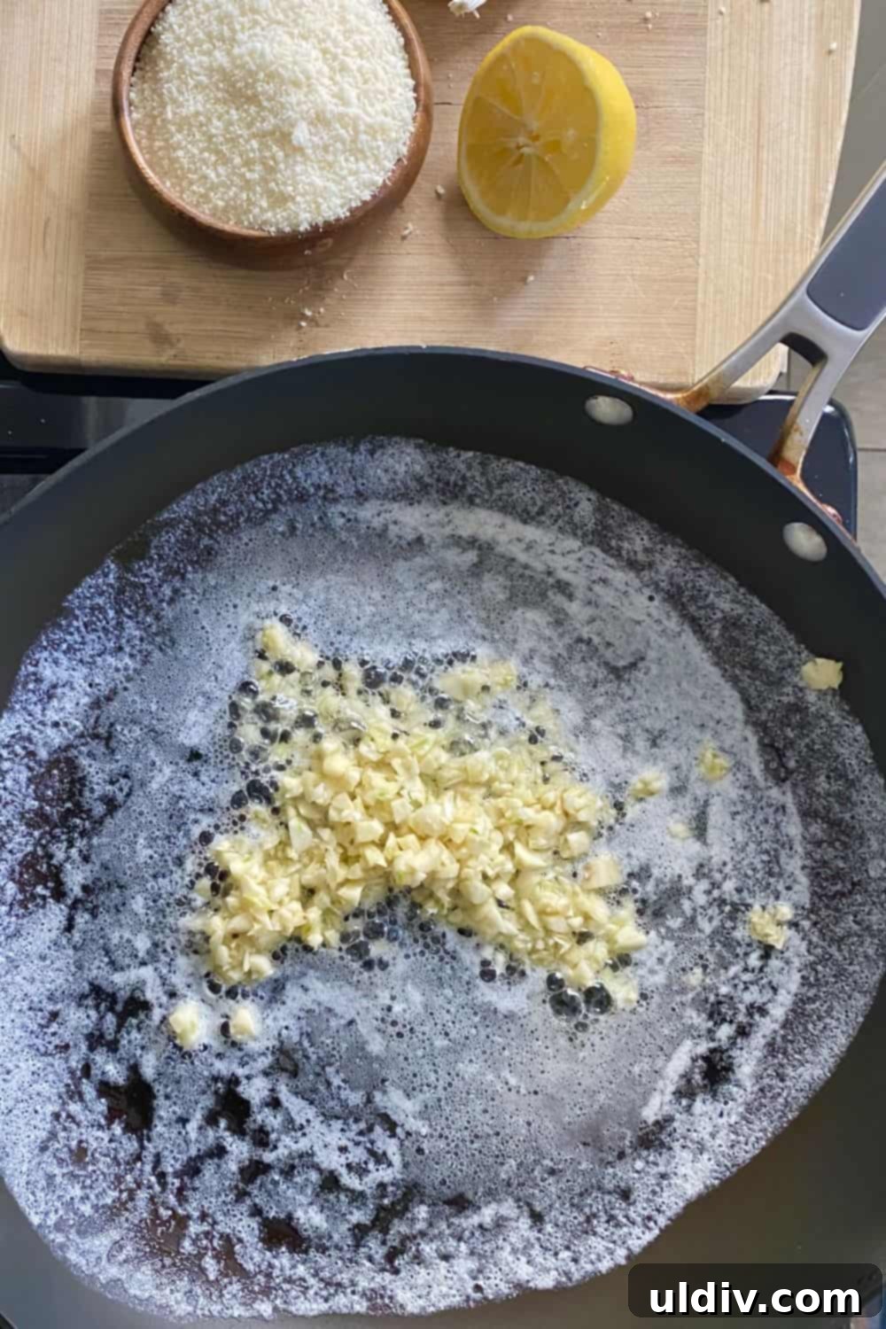 Creamy Garlic Parmesan Noodles 6 Melted butter, olive oil, and finely chopped garlic simmering gently in a sauté pan, creating the aromatic base for the sauce.
