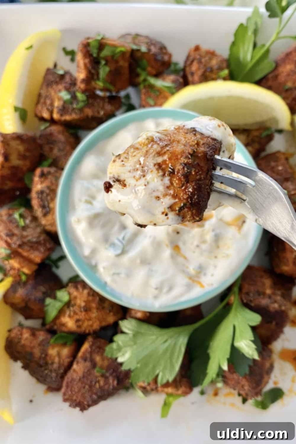 Spiced Tuna Poppers with Tangy Pickle Dip 2 Delicious blackened tuna bites dipped in a creamy sweet pickle sauce, ready to be served.