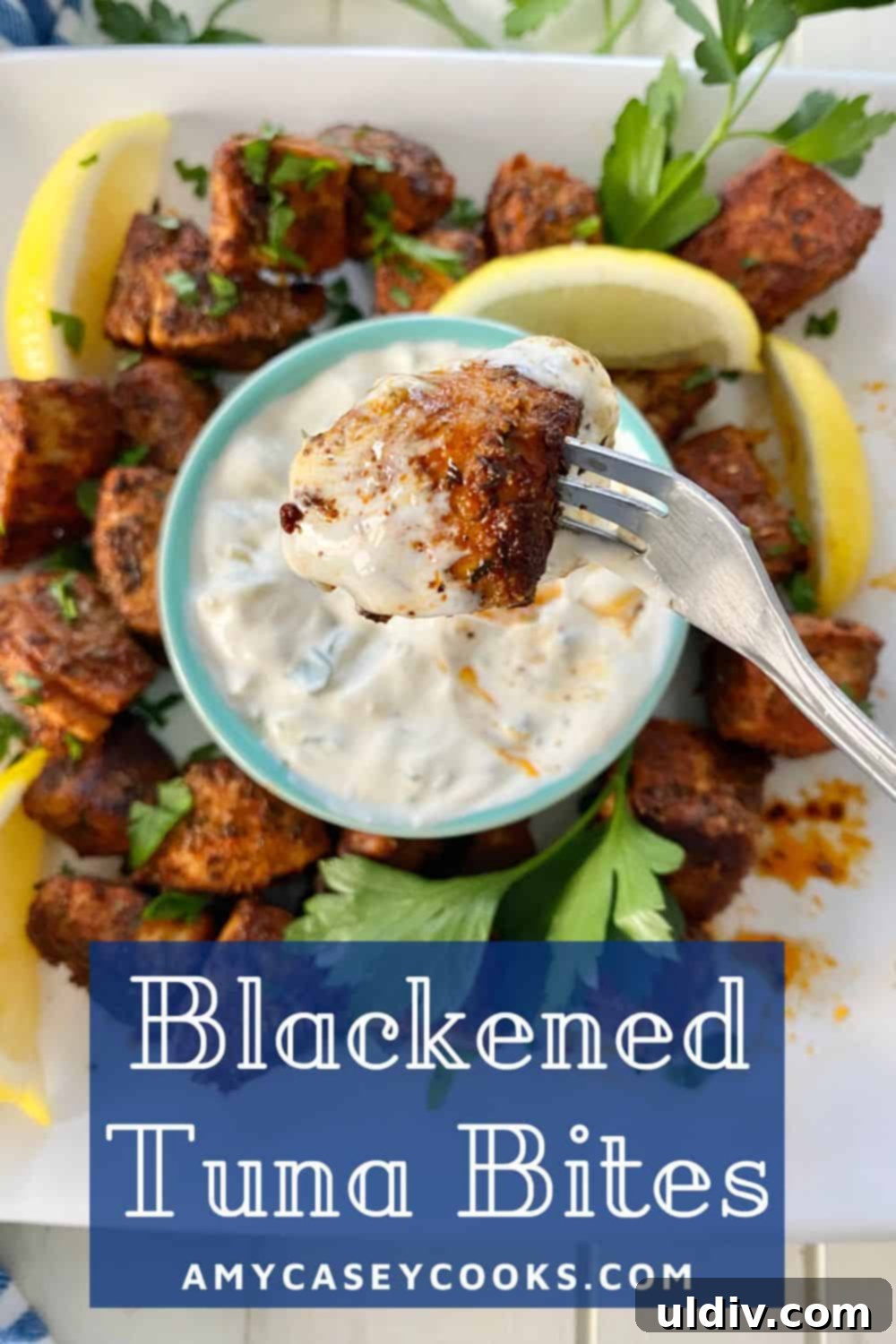 Spiced Tuna Poppers with Tangy Pickle Dip 12 A perfectly cooked blackened tuna bite on a fork, showcasing its tender interior and crispy exterior, ready to be enjoyed.