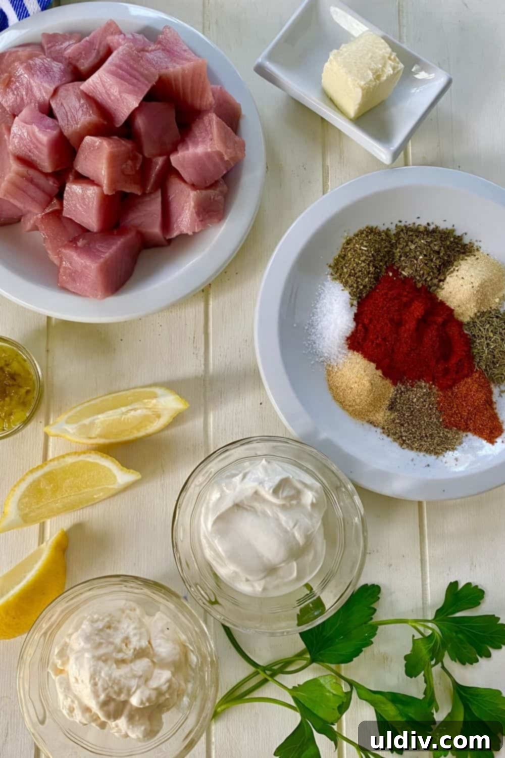 Spiced Tuna Poppers with Tangy Pickle Dip 3 A collection of fresh ingredients including tuna, lemon, spices, butter, mayonnaise, and sour cream, laid out for the blackened tuna bites recipe.