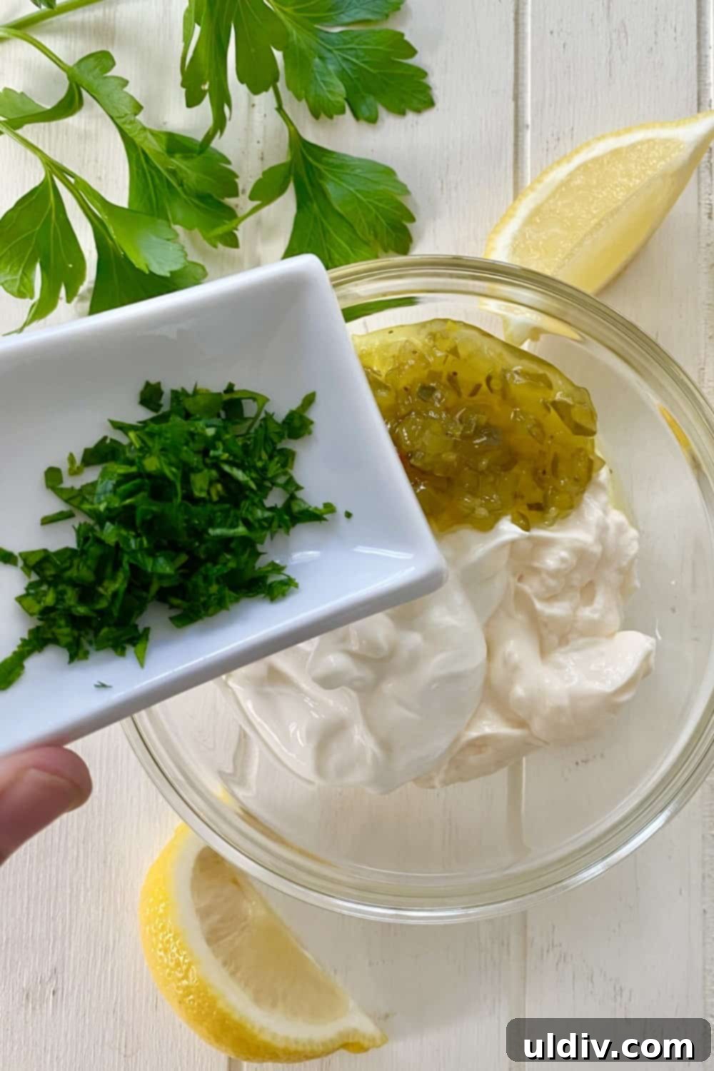 Spiced Tuna Poppers with Tangy Pickle Dip 5 Ingredients for the sweet pickle dipping sauce including sour cream, mayonnaise, sweet pickle relish, fresh parsley, and lemon.