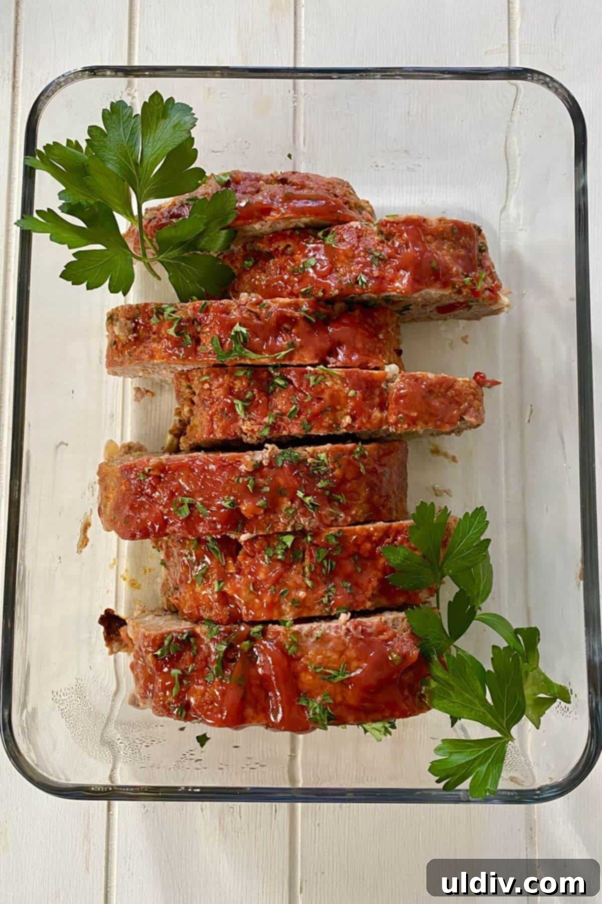 The Ultimate Mom's Meatloaf 8 Mom's meatloaf sliced and in a glass dish.