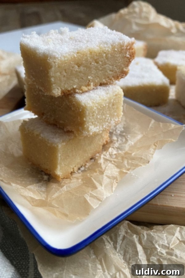 New York Times-Approved Sugared Shortbread 3 A perfectly stacked assortment of all-butter shortbread cookies, highlighting their uniform golden appearance and inviting texture.