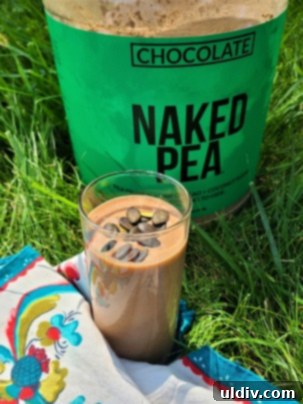 Naked Nutrition Chocolate Pea Protein Powder A Deliciously Wholesome Review 4 A serving of Naked Nutrition Chocolate Pea Protein Powder with a scoop and a measuring spoon.